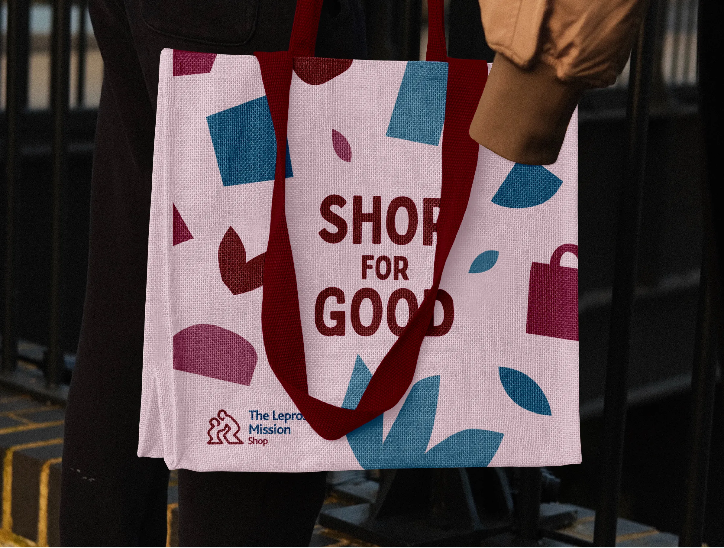 A canvas tote bag in new Leprosy Mission Shop branding with the slogan "Shop For Good"