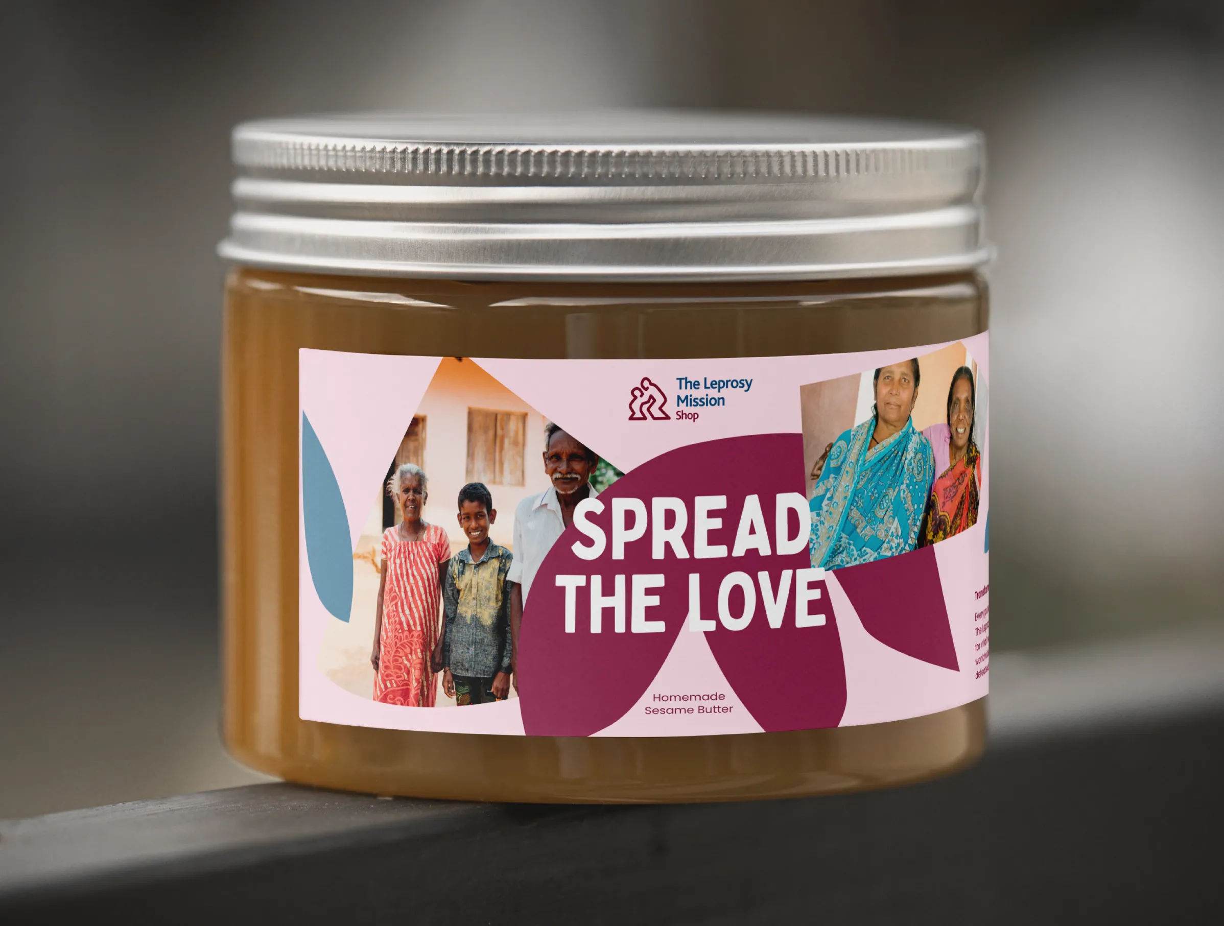 Mock of of a tub of sesame butter in Leprosy Mission Shop branding - copy says "Spread the love"